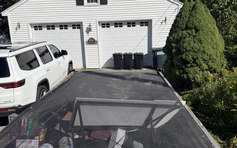 Covered trailer outside a Maine home