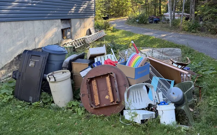 Household furniture gathered outdoors for hauling