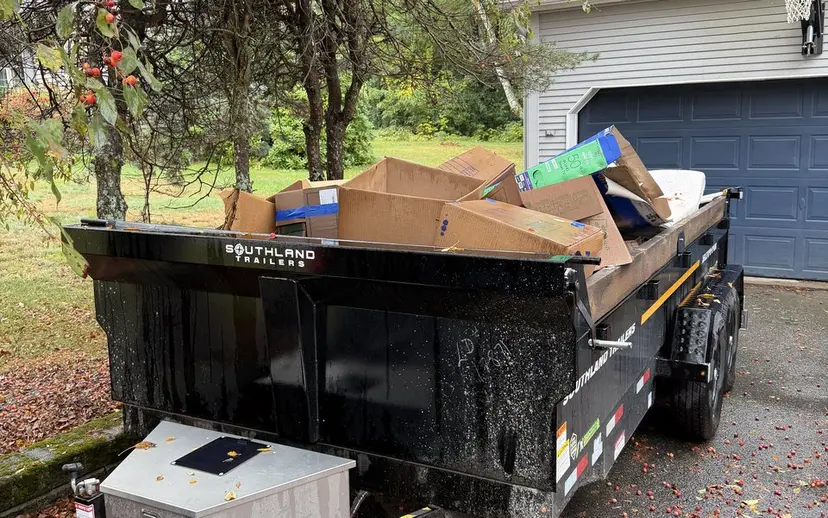 Covered trailer loaded with household debris