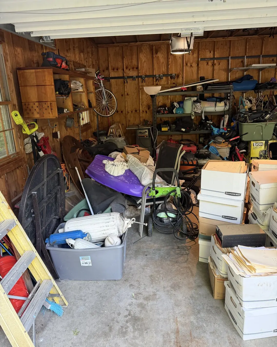 Garage crowded with boxes and household equipment