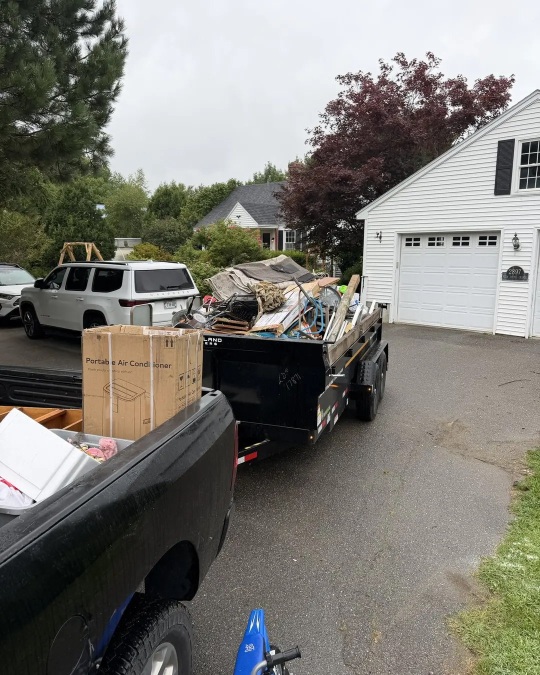 Loaded removal trailer outside a Maine house